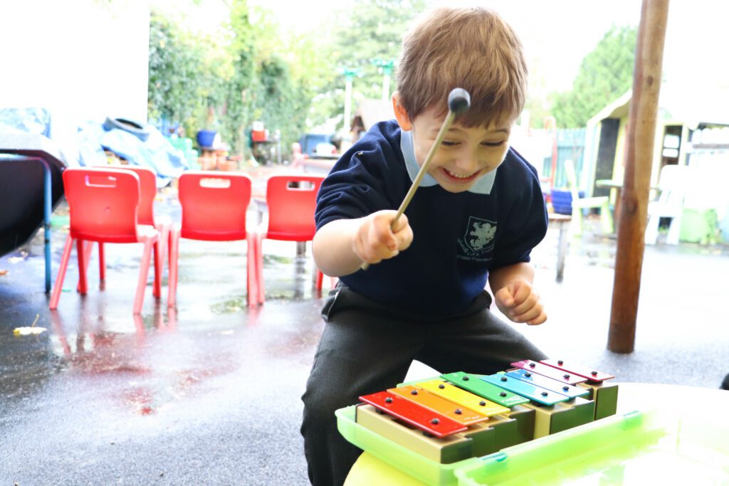 child playing music in eyfs class at rosherville academy