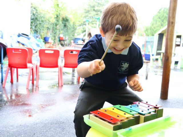 child playing music in eyfs class at rosherville academy