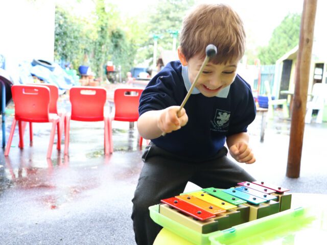 child playing music in eyfs class at rosherville academy