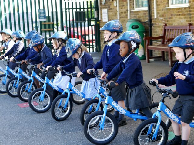 children in eyfs using balance bikes at rosherville cofe academy