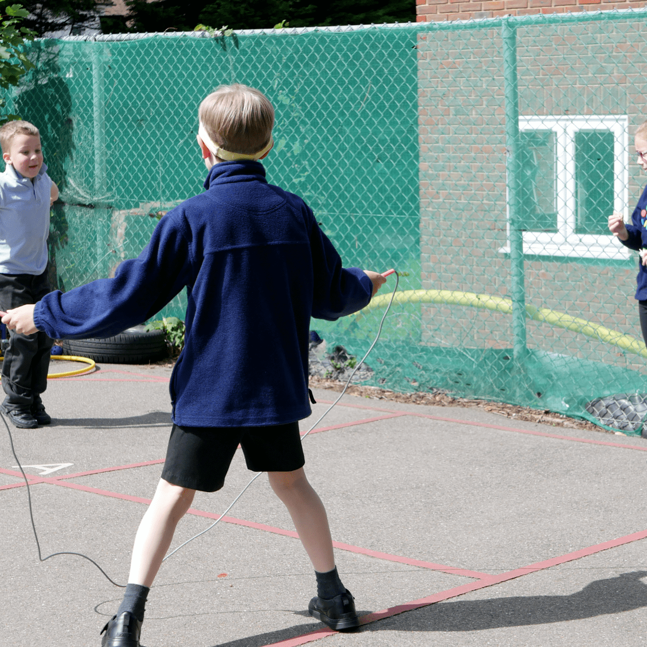 children skipping on the playground at rosherville cofe academy