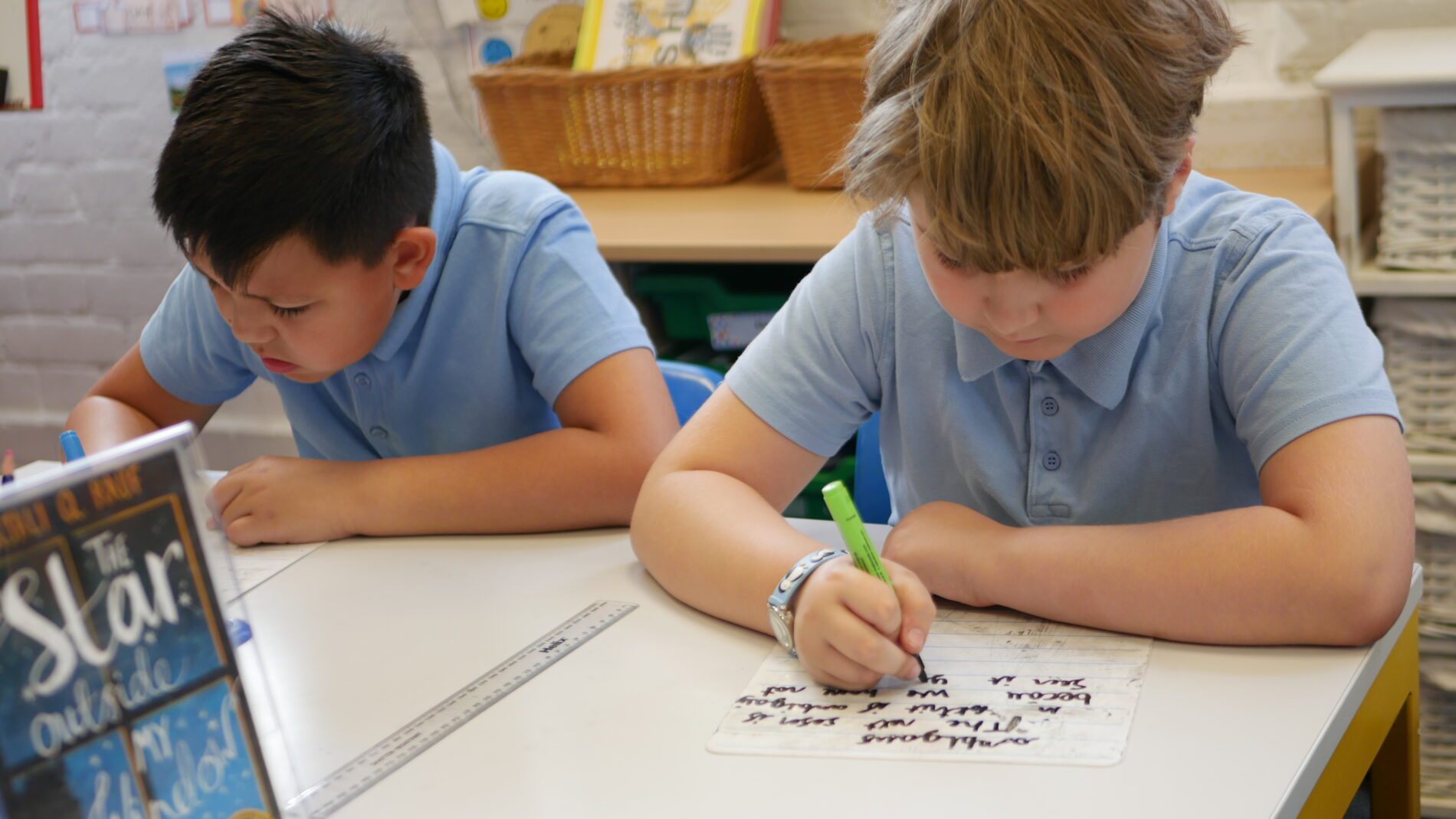 children writing on whiteboards at rosherville cofe primary