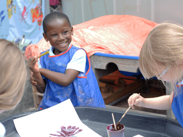 child painting in eyfs at rosherville cofe academy