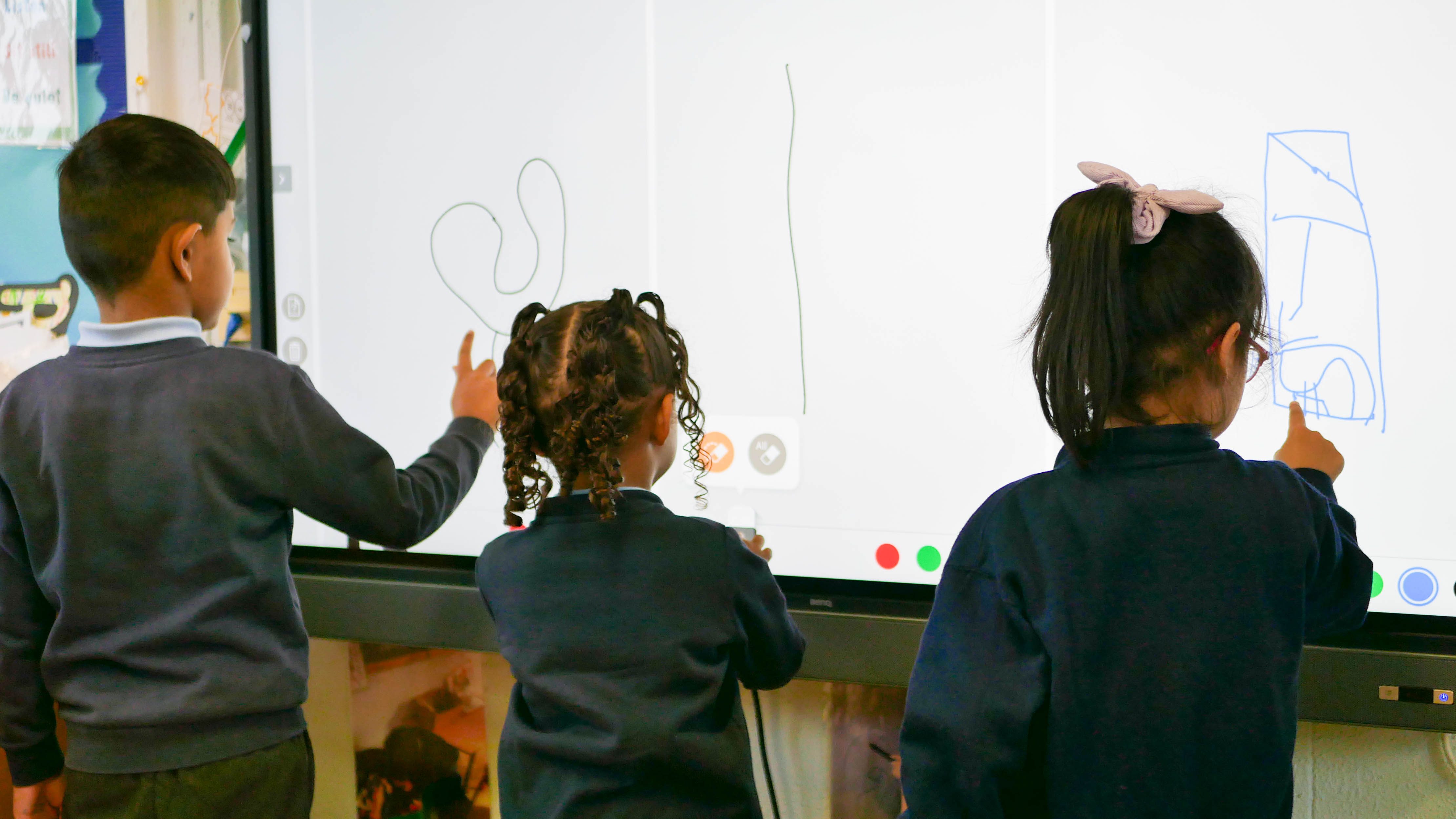 children in eyfs drawing on the board at rosherville academy