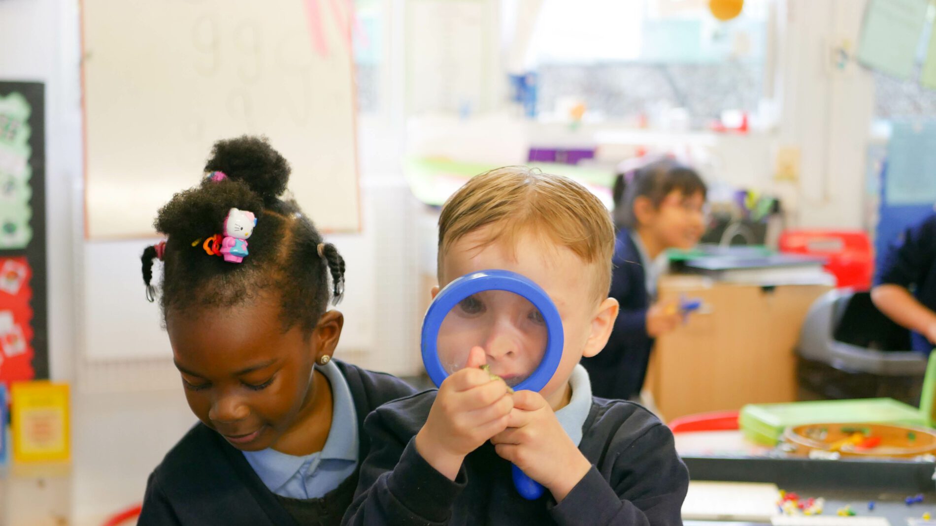 P1200438 children at rosherville academy using magnifying glasses in science