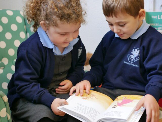 children in eyfs reading together at rosherville cofe academy